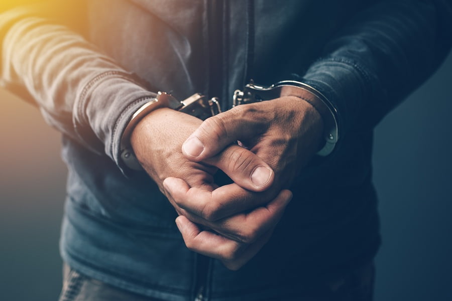 Arrested defendant with handcuffs