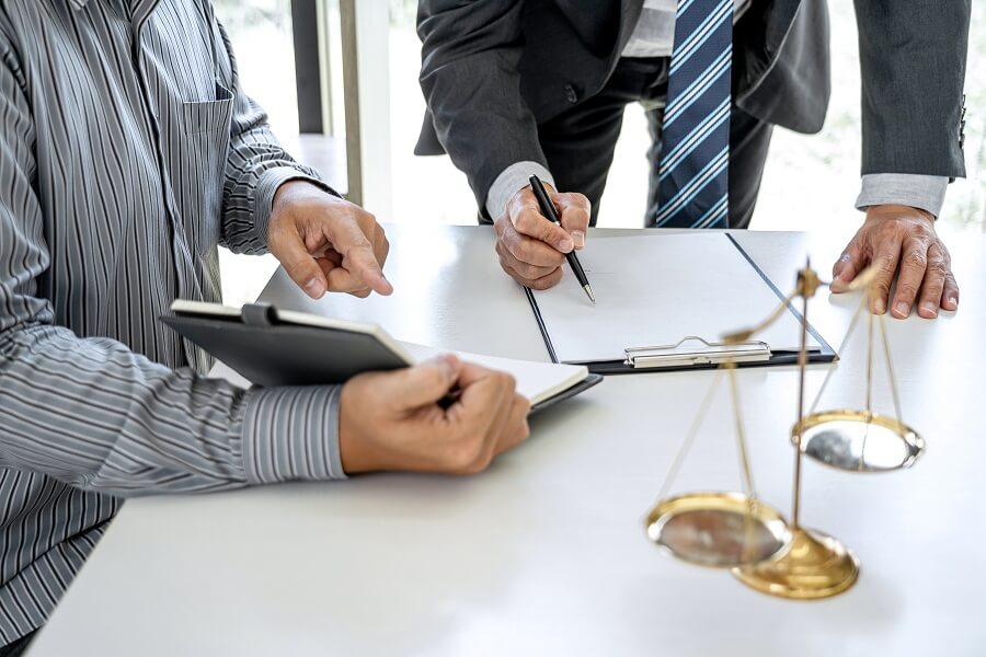 male lawyer signing a document