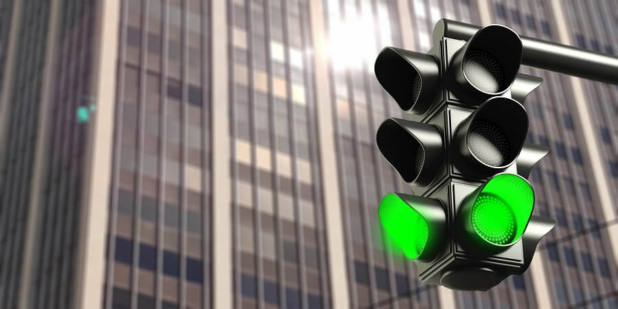 green traffic lights in a busy city