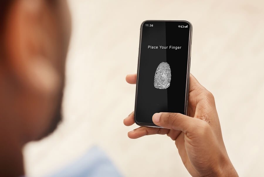 man holding phone with fingerprint scan app