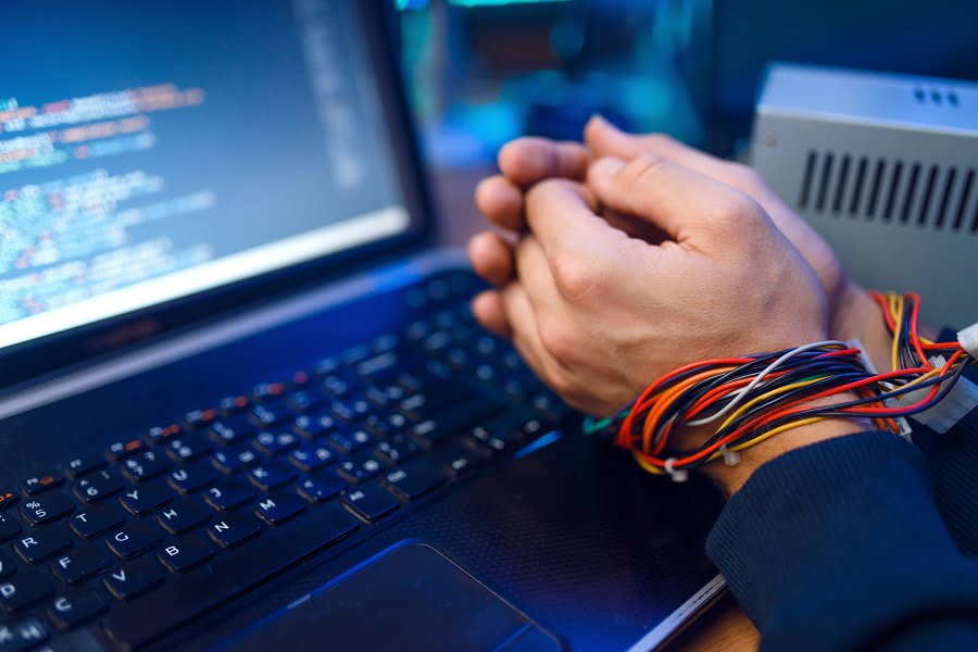 Hacker hands tied with wires
