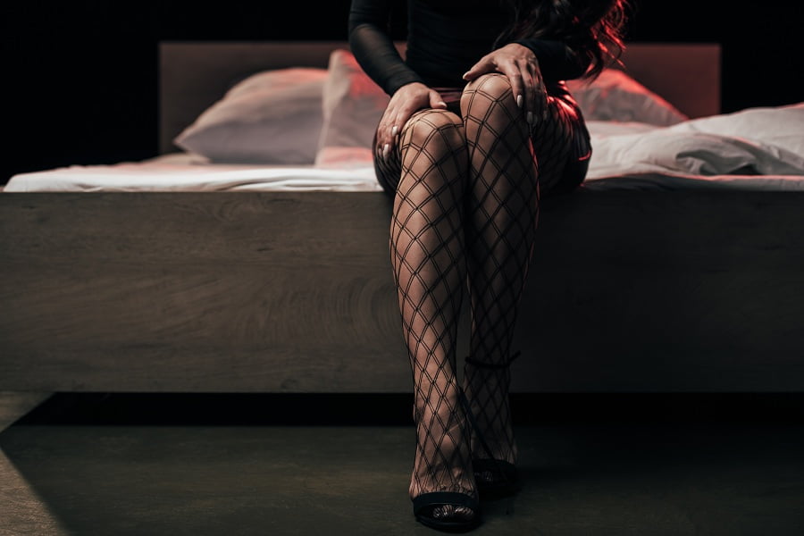 Prostitute wearing mesh stockings